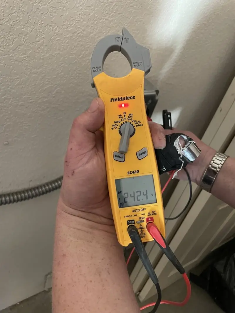 Voltage testing with clamp meter during Electrical Installation Services in Genoa